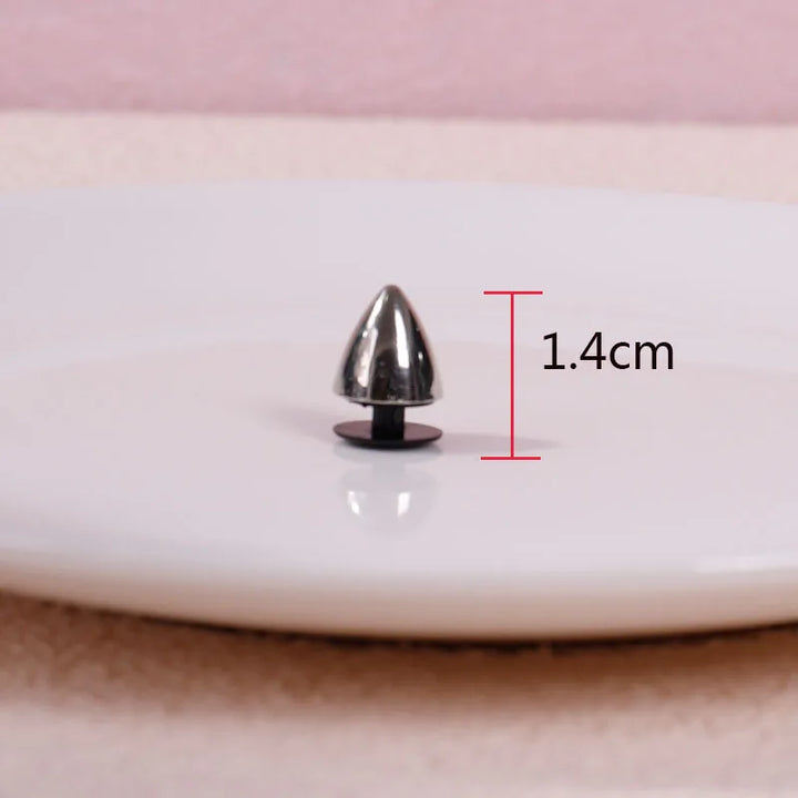 Metallic spike on a white surface with measurement label