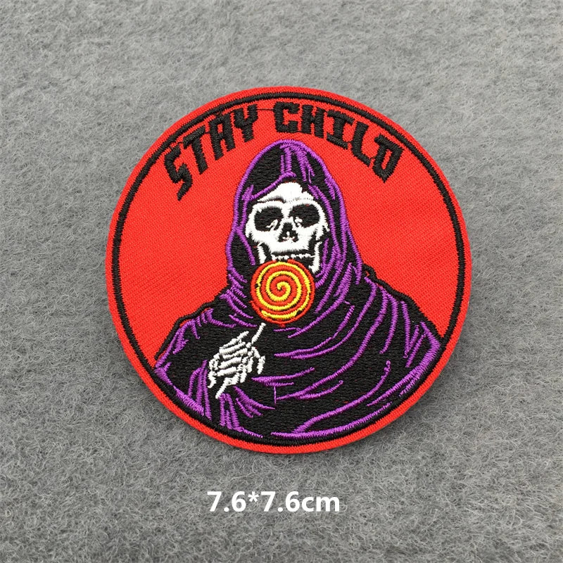Patch with a skeleton holding a lollipop and 'Stay Child' text on a gray background