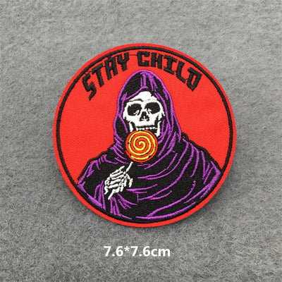 Patch with a skeleton holding a lollipop and 'Stay Child' text on a gray background