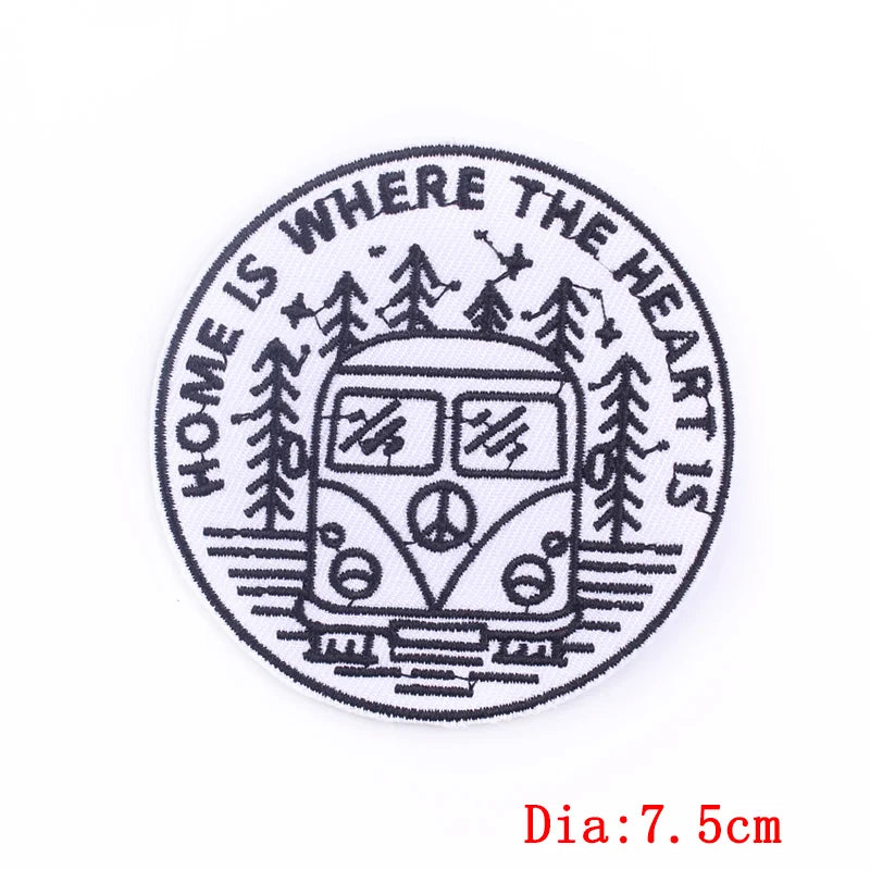 Circular design with a camper van, trees, and 'Home is where the heart is' text on a white background.