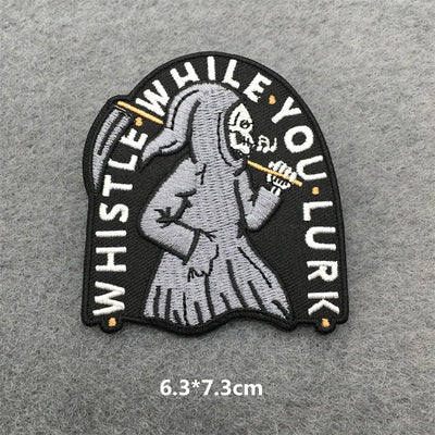 Embroidered patch with skeleton holding a whistle on a gray background