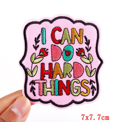 Motivational patch with 'I can do hard things' text held by a hand on a white background