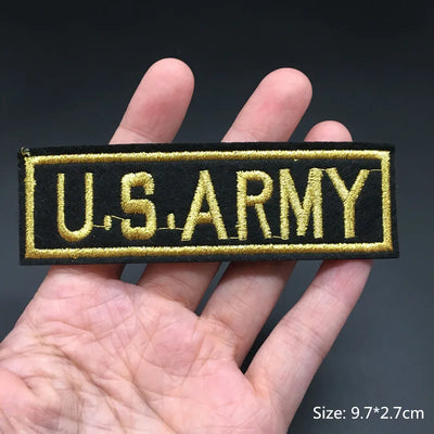 U.S. Army patch held in a hand with a dark background
