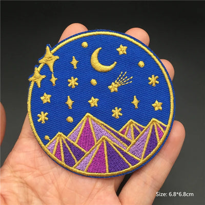 Embroidered patch with celestial design held in a hand