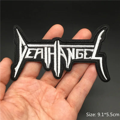Embroidered patch with 'DEATH ANGEL' text held in a hand against a dark background