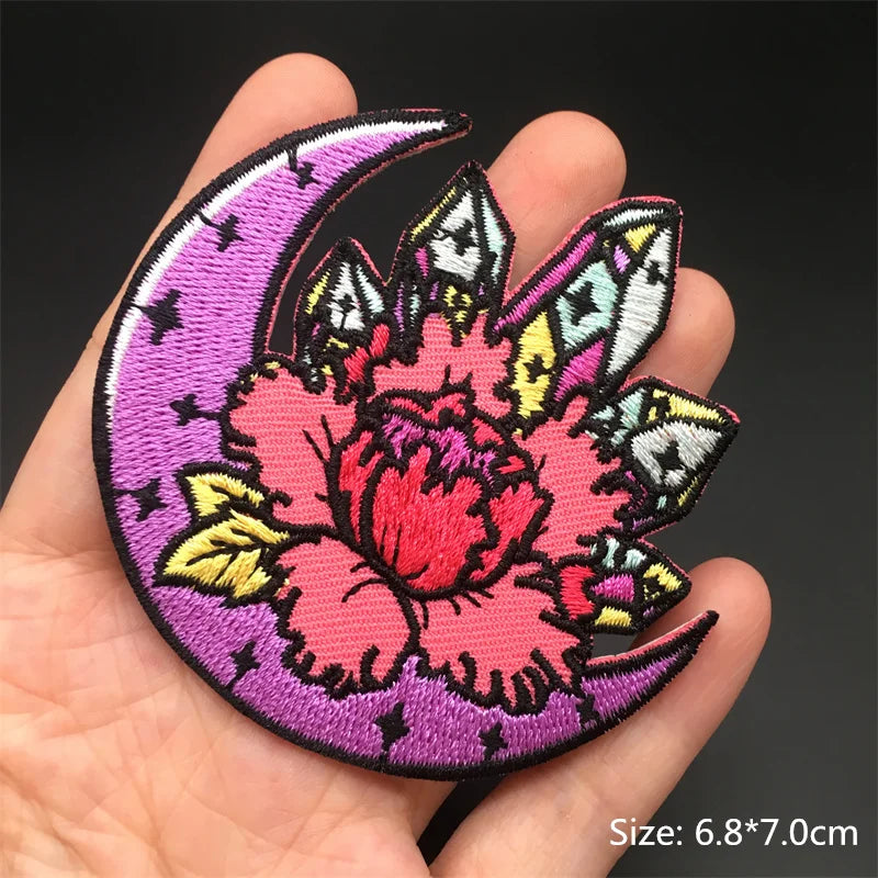 Decorative patch with pink flower and purple crescent moon held in a hand, size 6.8*7.0cm.