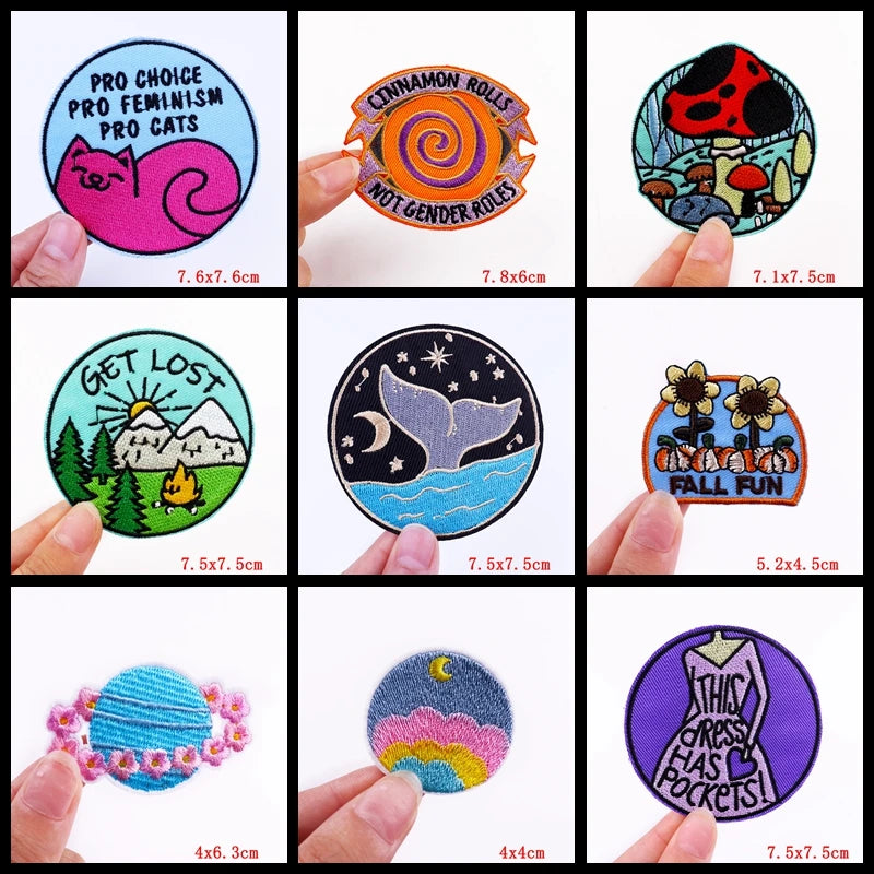 Collection of various patches with different designs and text, held by hands.