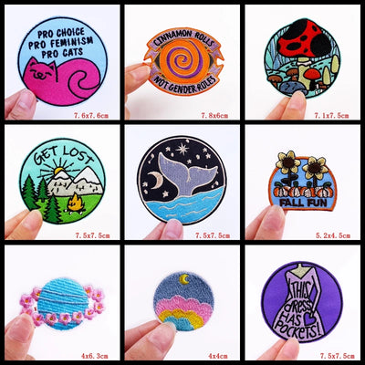 Collection of various patches with different designs and text, held by hands.