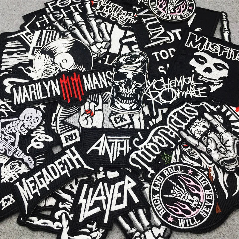 Collection of black and white music-themed patches featuring band logos and designs.