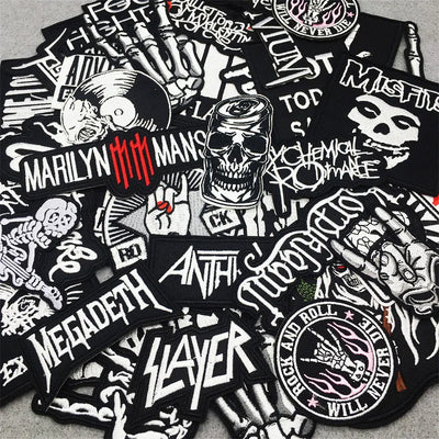 Collection of black and white music-themed patches featuring band logos and designs.