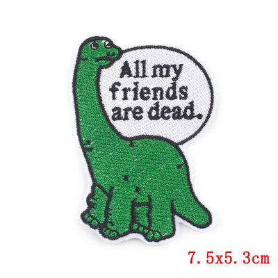 Green dinosaur patch with a speech bubble saying 'All my friends are dead' on a white background.