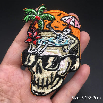 Embroidered patch with skeleton design held in a hand against a dark background