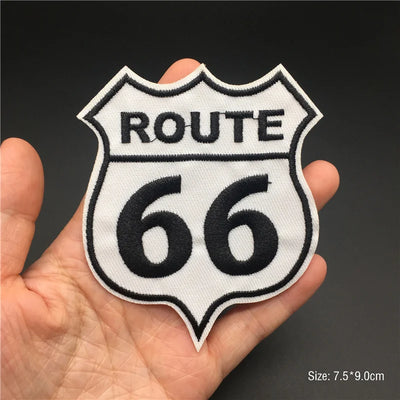 Route 66 patch held in a hand with a dark background