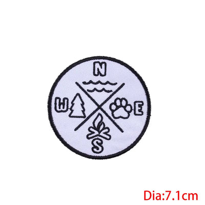 Circular patch with nature-themed symbols and 'N W E S' text on a white background