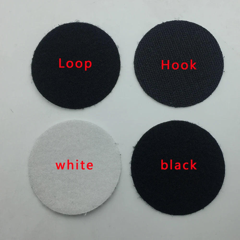 Four black, white, and gray adhesive Velcro patches labeled &