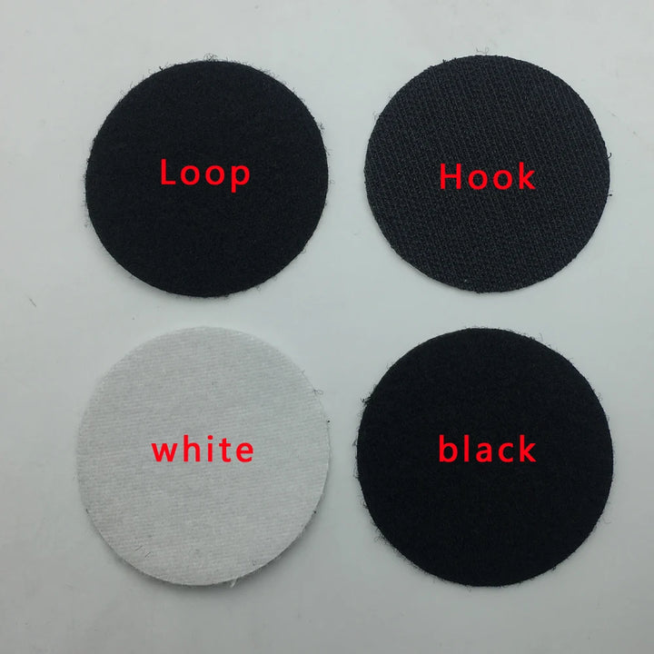 Four black, white, and gray adhesive Velcro patches labeled &