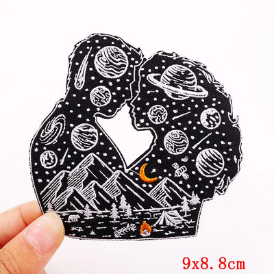Embroidered patch with space-themed design held by a hand, showing measurement '9x8.8cm'.