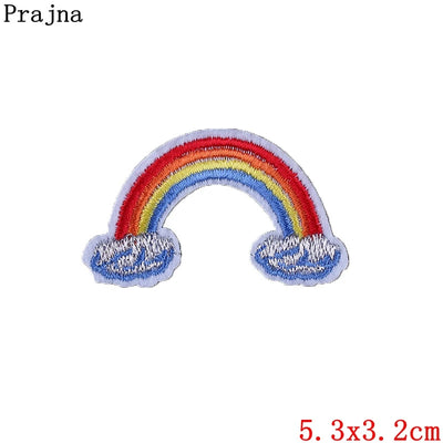 Colorful rainbow patch with clouds on a white background, featuring the brand 'Prajna'.