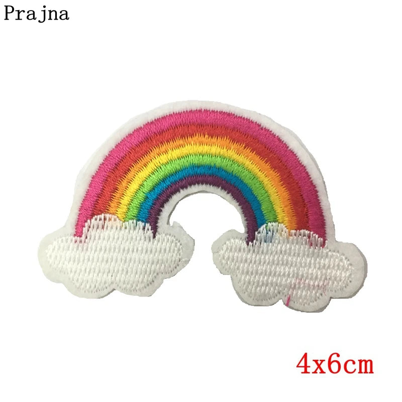 Embroidered rainbow patch with clouds on a white background