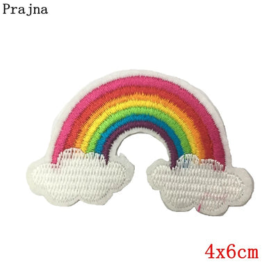 Embroidered rainbow patch with clouds on a white background