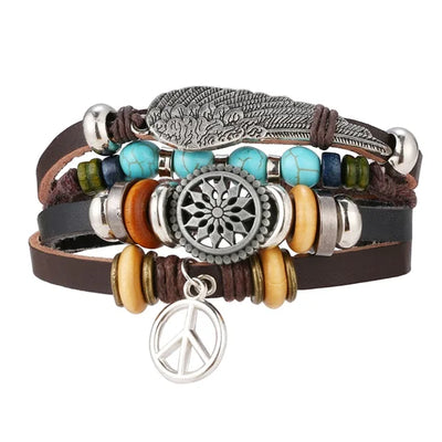 Multistrand bracelet with feather, wheel, and peace sign charms on a white background