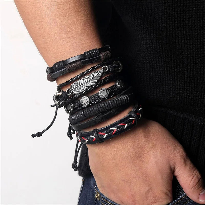 Multiple leather bracelets with metal accents on a wrist against a neutral background
