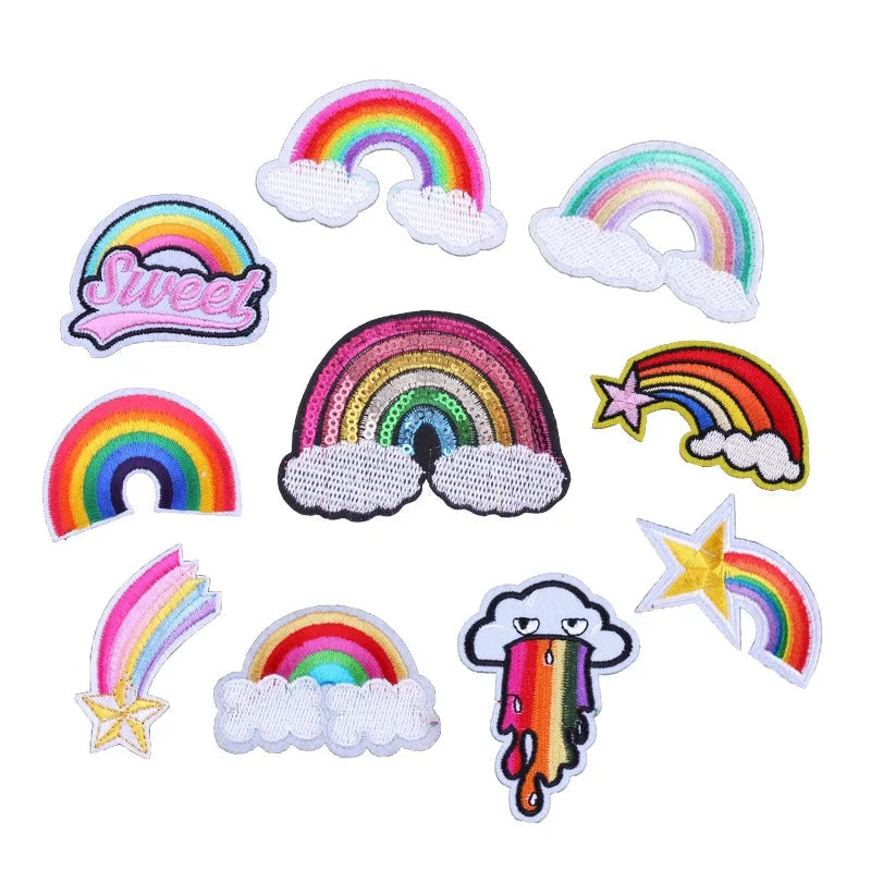 Collection of rainbow-themed patches with various designs on a white background.