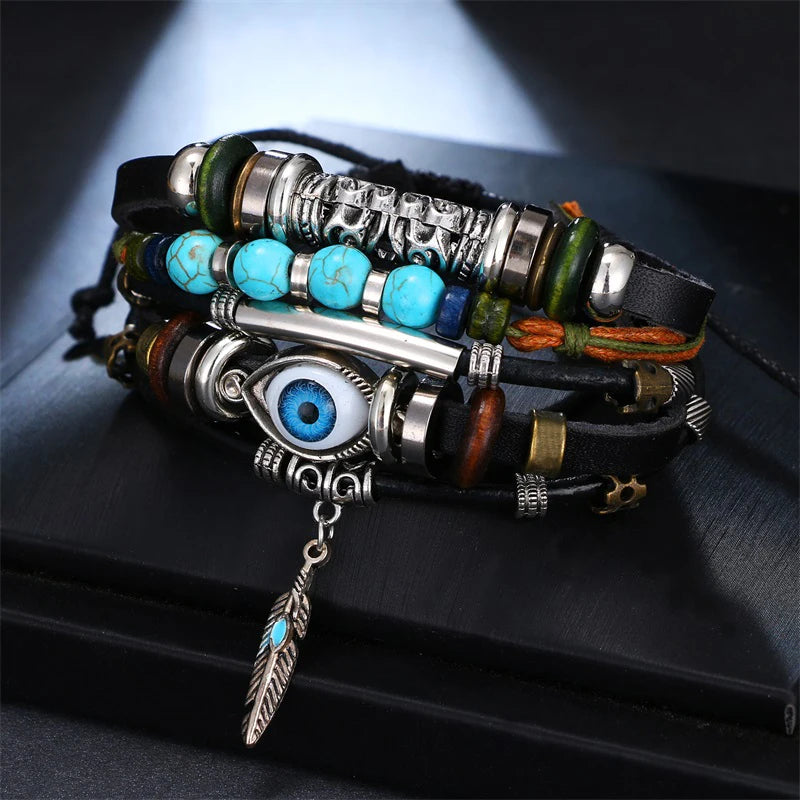 Multistrand bracelet with beads and eye charm on a dark surface