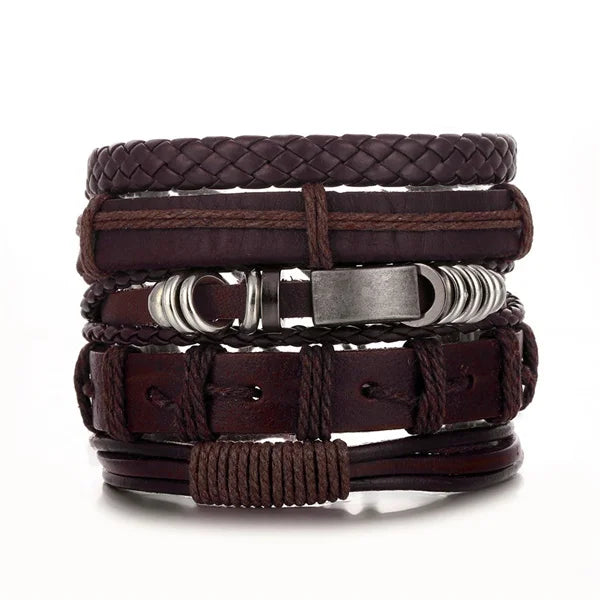 Stack of brown leather bracelets with metal accents on a white background