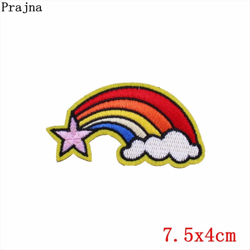Embroidered patch with a rainbow, cloud, and star on a white background