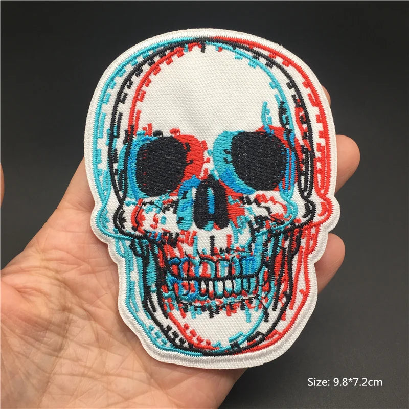Colorful skull patch held in a hand with a dark background