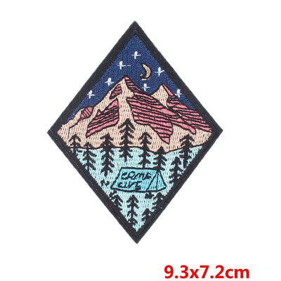Embroidered patch with mountain design on a white background