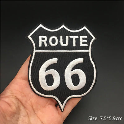 Route 66 patch held in a hand with a dark background