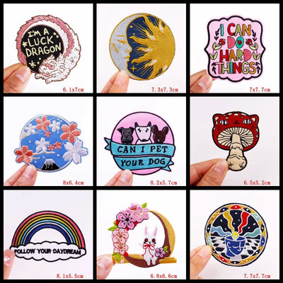 Collection of various colorful patches held by hands with dimensions displayed.