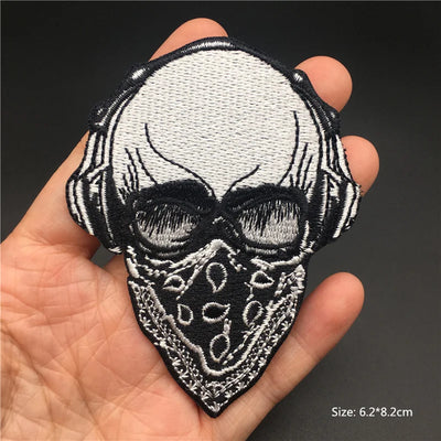 Skull patch held in a hand with a dark background