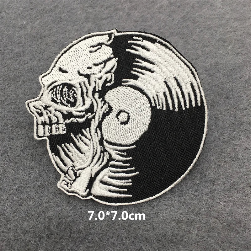 Embroidered patch with skull and vinyl record design on a gray background