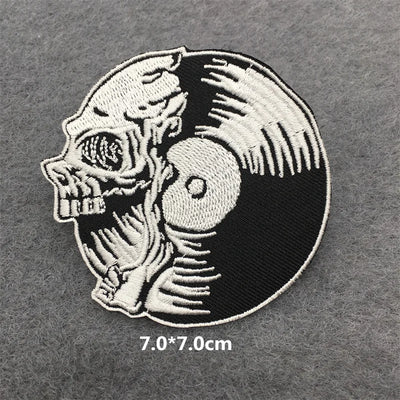 Embroidered patch with skull and vinyl record design on a gray background