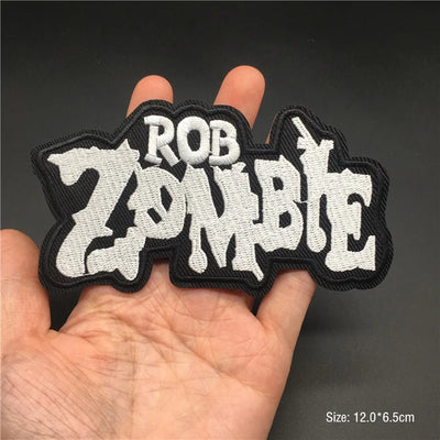 Rob Zombie patch held in a hand with a dark background