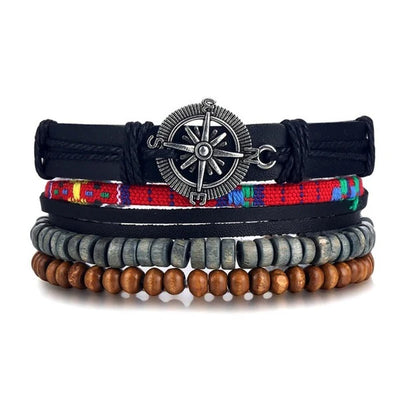 Stack of bracelets with a compass charm on a white background