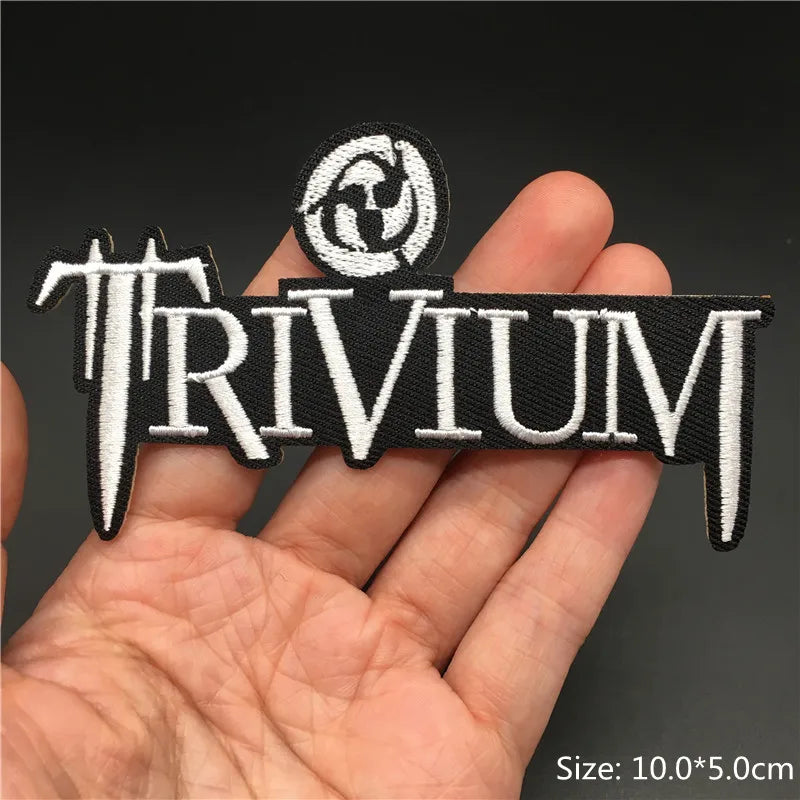 Thrivium patch held in a hand with a dark background