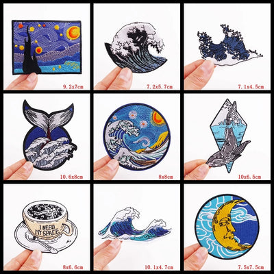Collection of various artistic stickers held by hands with dimensions displayed.