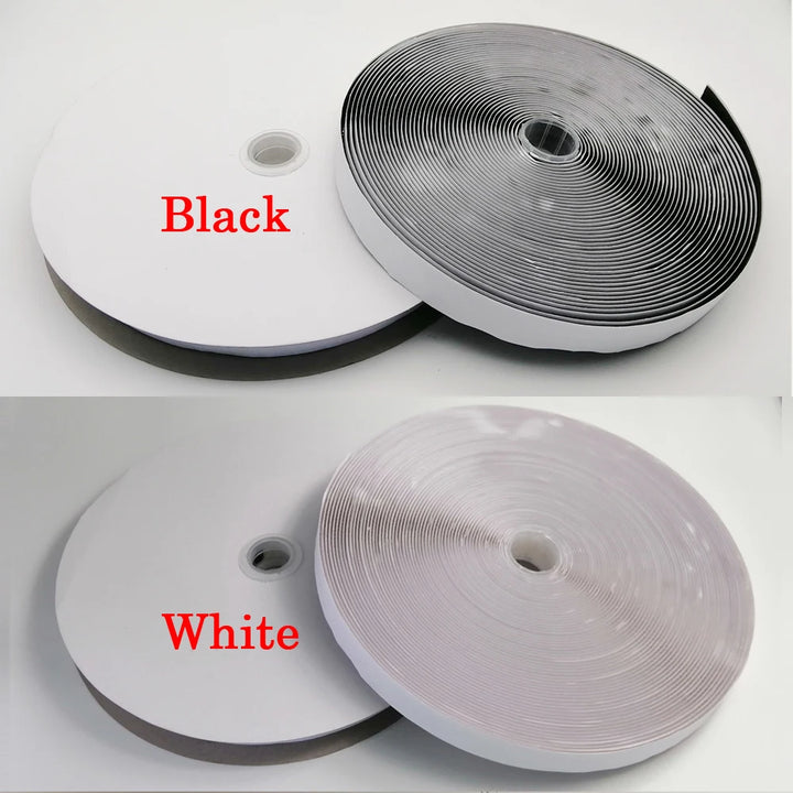 Two rolls of Velcro tape, one black and one white, on a white background.