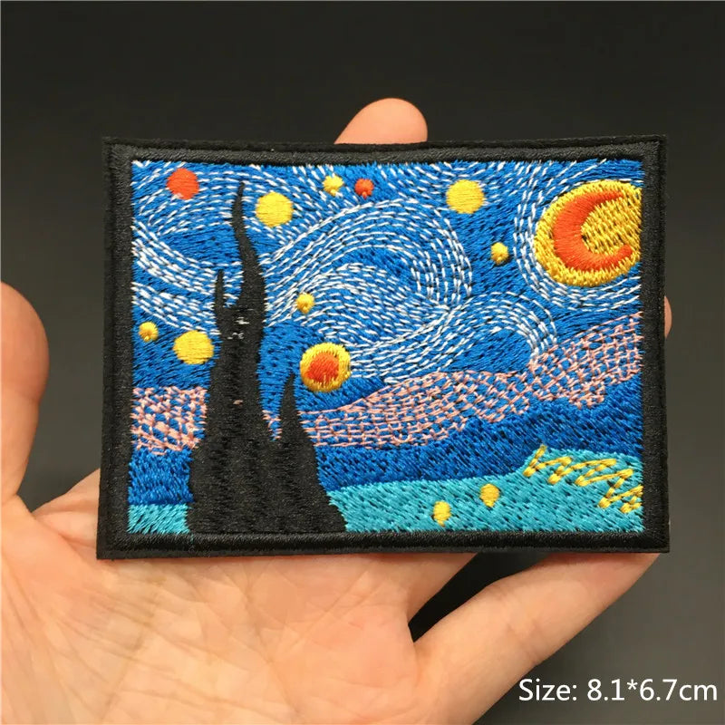 Embroidered patch of 'Starry Night' held in a hand with a dark background
