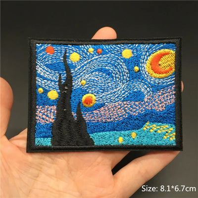 Embroidered patch of 'Starry Night' held in a hand with a dark background