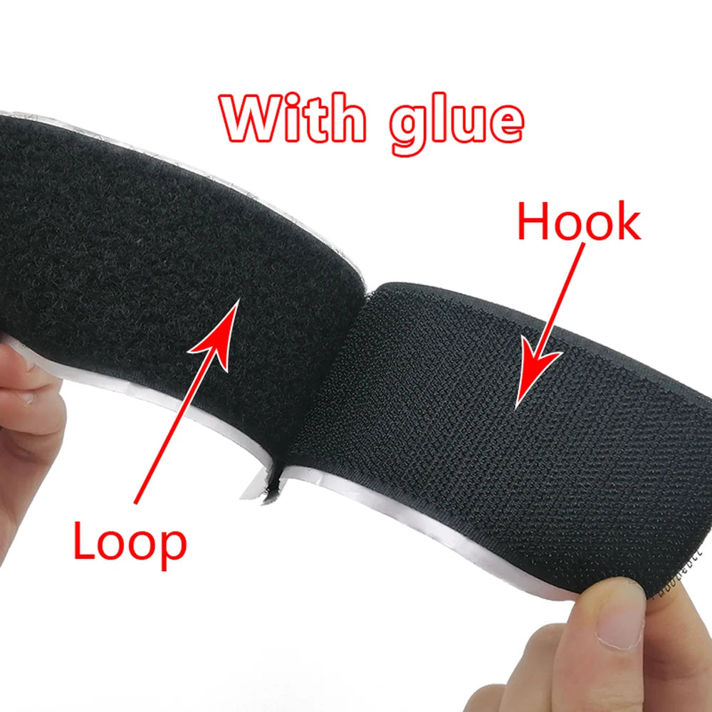 Black Velcro tape held by a hand with glue, hook, and loop labeled on a white background