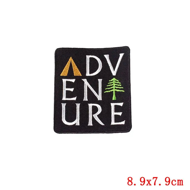 Embroidered patch with 'ADVENTURE' text and camping symbols on a black background