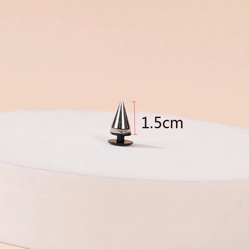Metallic cone-shaped object with measurement label on a beige background