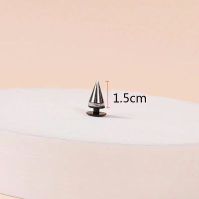 Metallic cone-shaped object with measurement label on a beige background