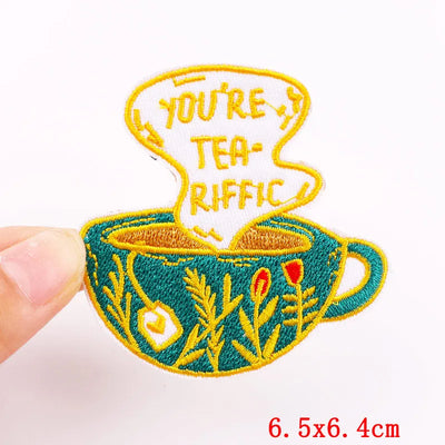 Embroidered patch with a teacup design and 'You're Tea-Riffic' text on a white background.