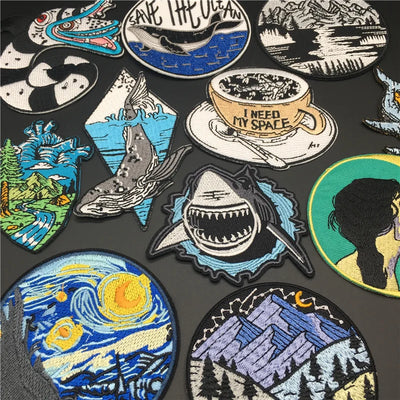 Collection of various embroidered patches on a dark background